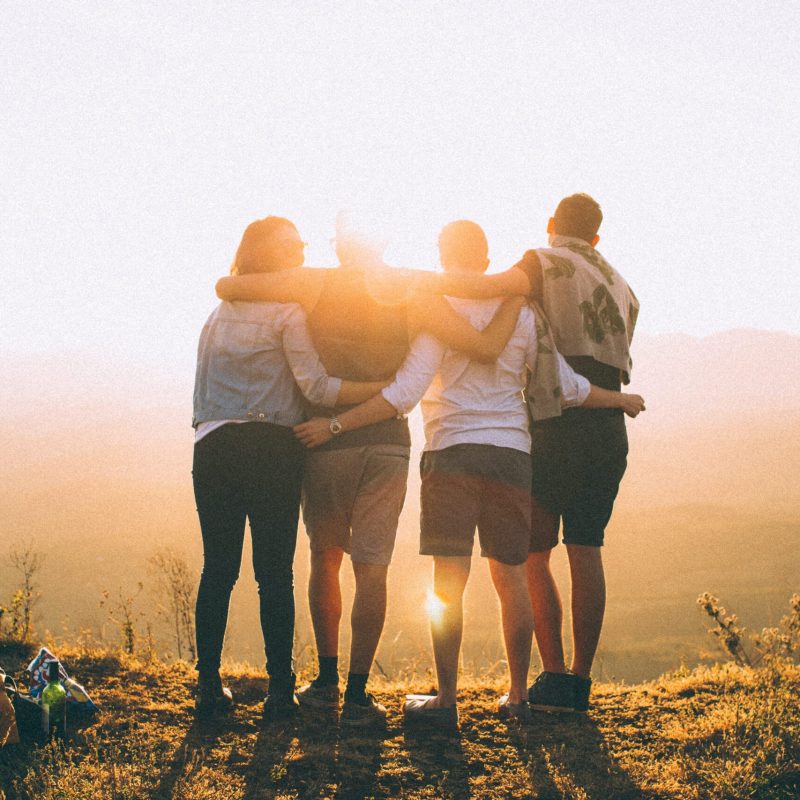 https://unsplash.com/photos/four-person-hands-wrap-around-shoulders-while-looking-at-sunset-PGnqT0rXWLs
